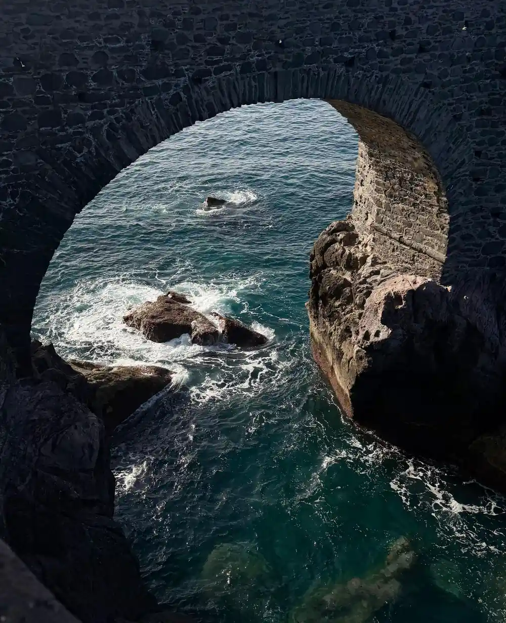Coastal viewpoint overlooking rocky terrain and distant sea