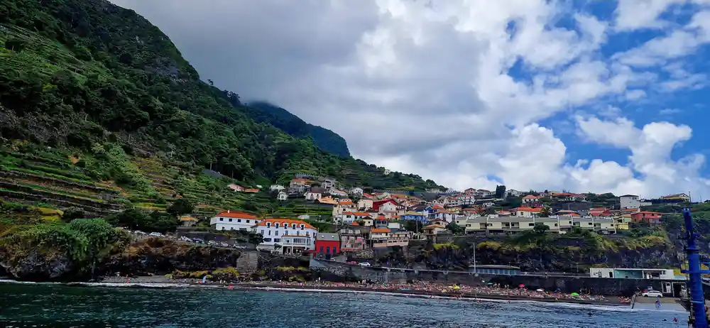 Colorful hillside village with terraced houses by sea