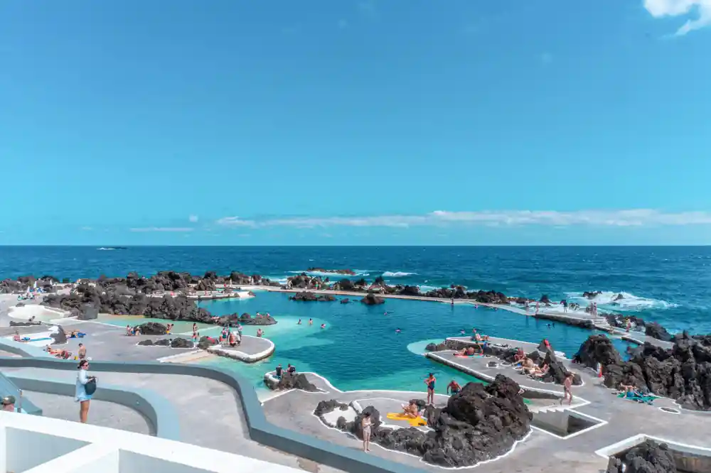 Modern swimming pools integrated with rocky coastline and ocean