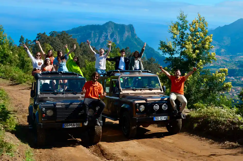 People on vehicles with mountain valley backdrop